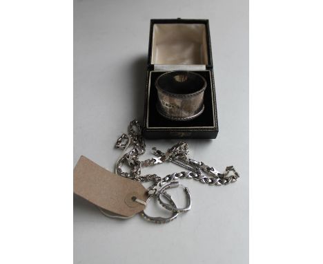 A boxed silver napkin ring, silver bracelet and chain, pair of earrings and a golf bar brooch 