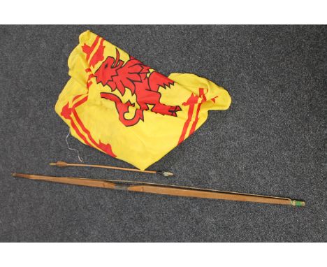 An archery longbow and arrow together with a Scottish flag 