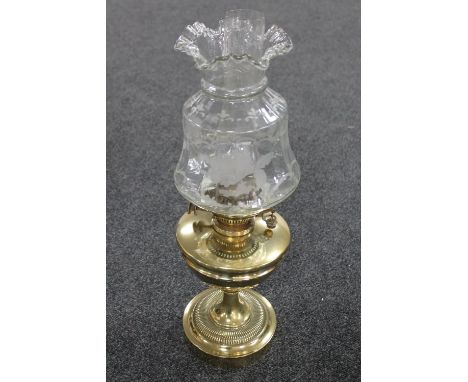A Victorian brass Benetfink oil lamp with etched shade and glass chimney 