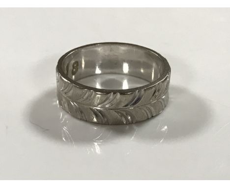 An 18ct white gold textured band ring, 5.2g, size L.