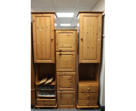 A pine bed surround fitted storage cupboards 