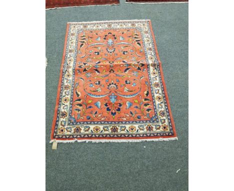 An Eastern carpet on salmon ground, 105 cm x 147 cm 