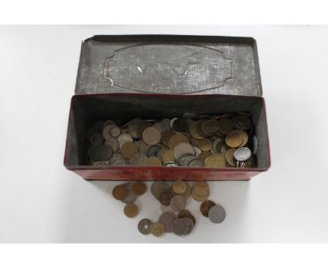 A vintage C.W.F. biscuit tin containing early 20th century and later foreign coins 