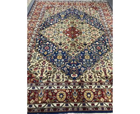 A fringed Persian woolen carpet on blue ground, 337cm by 251cm 