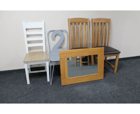 A pair of contemporary oak leather seated dining chairs together with a ladder backed chair, French style cafe chair and wall