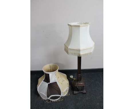 A carved oak Gothic style table lamp with shade together with an ornate standard lamp shade 