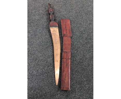 An African sword in leather scabbard 