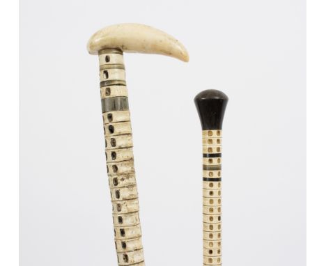 A shark vertebra walking stick with an ivory handle and another with ebonised handle Condition Report: Lot contains an elemen