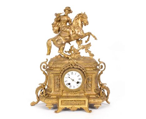 A French gilt metal cased mantel clock, surmounted by a figure of a horseman in 17th Century dress, the white enameled dial w