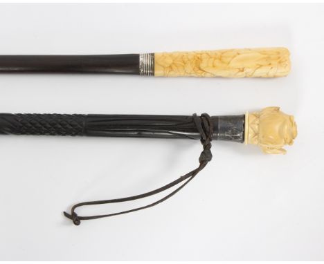 An ebonised walking stick, the carved ivory handle in the form of a rose with a silver mount and another ebonised walking sti