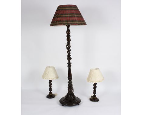 A standard lamp and two table lamps on twist turned columns Condition Report: There is an additional table lamp with this lot