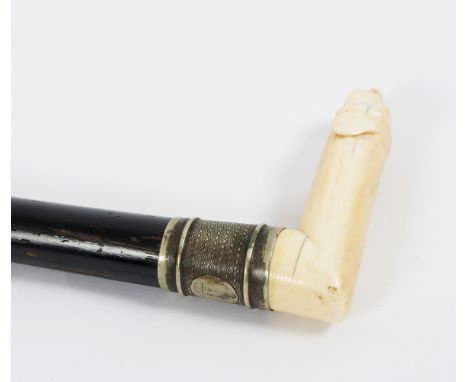 An ebonised walking stick, the carved ivory handle in the form of a dachshund Condition Report: Lot contains an element of pr