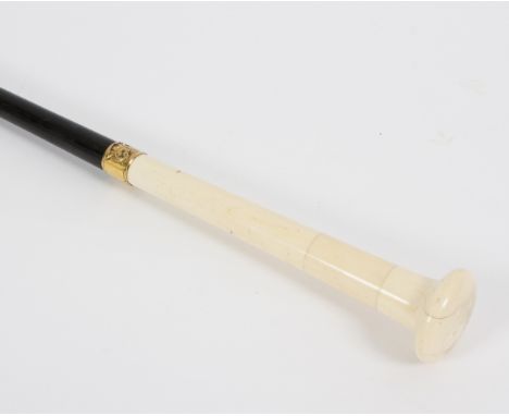 An ebonised walking stick with tapered ivory handle and stopped finial with gilt metal collar Condition Report: Lot contains 