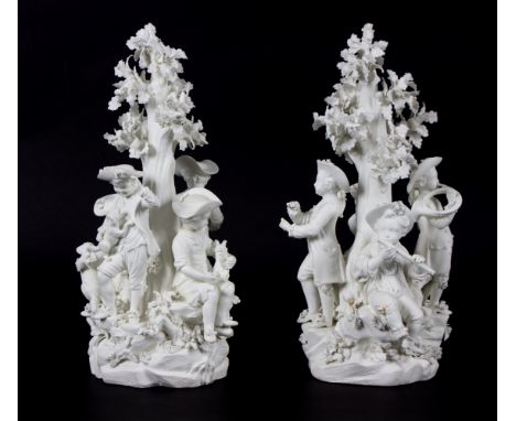 A pair of Derby biscuit groups, circa 1785, one youths with animals, the other youths with musical instruments, each around a
