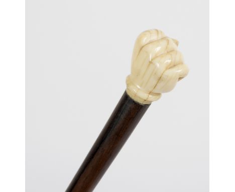 A malacca walking stick, the carved ivory handle in the form of a clenched fist Condition Report: Lot contains an element of 