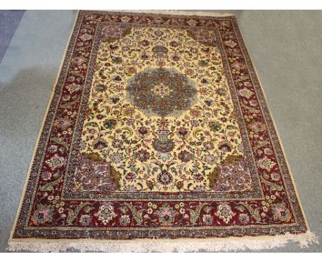 A modern Persian carpet with central floral field on a camel ground, 272cm x 194cm