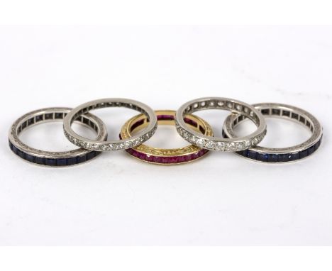 A diamond eternity ring set in precious white metal, size P½, another similar (lacking a stone), size Q, two sapphire eternit