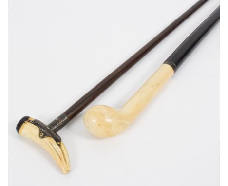 An ebonised walking stick with club shaped ivory handle and another walking stick with ivory finial Condition Report: Lot con