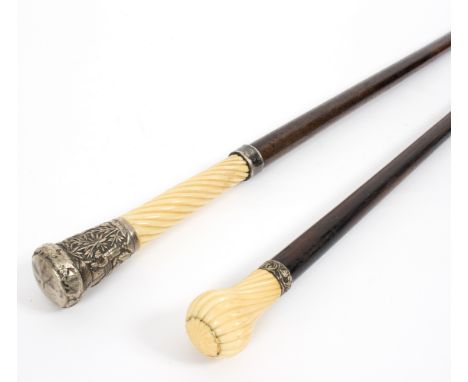 An ebonised walking stick with spirally ribbed ivory handle and embossed silver coloured metal mounts and another ebonised wa