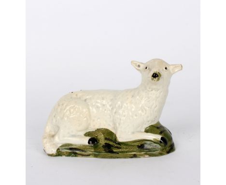 A late 18th Century pearlware model of a recumbent sheep, 16cm long