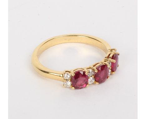 A ruby and diamond ring, the three oval rubies interspersed by pairs of diamonds, claw set to an 18ct yellow gold shank