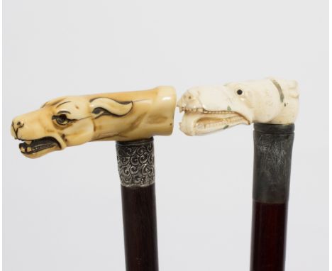 A walking stick, the carved ivory handle in the form of a greyhound and another of similar form  Condition Report: Lot contai