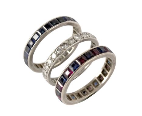 A diamond eternity ring, previously resized, set in unhallmarked white metal, size W½, a sapphire and ruby eternity ring set 