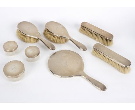 An eight-piece silver mounted dressing table set, London 1913, each engine turned and inscribed Jane/Provenance: Beverston Ca