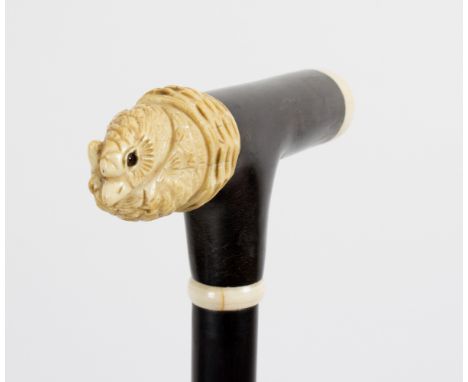 An ebonised walking stick, the carved ivory handle in the form of entwined bird heads/see illustration Condition Report: Lot 