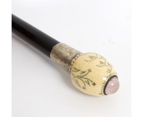 An ebonised walking stick, the ivory ovoid handle with foliate steel work decoration and semi-precious stone cabochon finial,