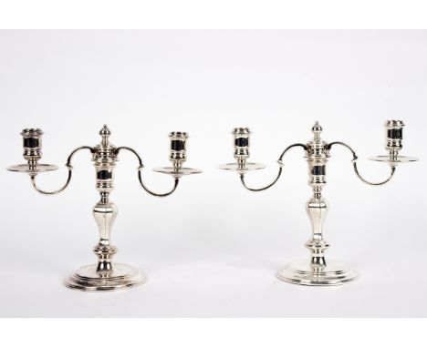 A pair of Regent plate two-branch two-light table candelabra, retailed by Garrard & Co., 20cm high/Provenance: Beverston Cast