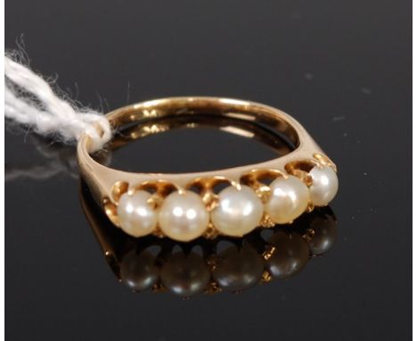 A modern yellow metal and pearl five stone ring, unmarked, tests as 9ct, 3.7g, size O