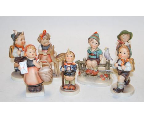 A collection of seven various Goebel figures to include School boy etc