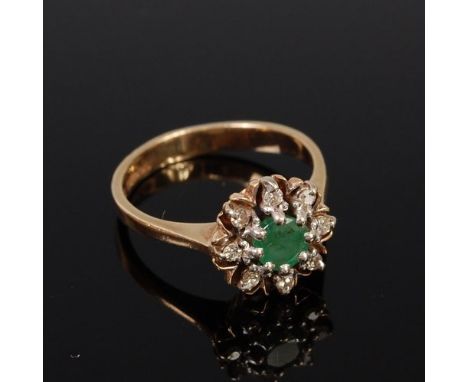 A 9ct gold, emerald and diamond flower head cluster ring, the round cut emerald weighing approx 0.5ct, 3.3g, size N