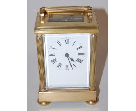 A 20th century lacquered brass cased carriage clock, having enamelled dial with Roman numerals and visible platform lever esc