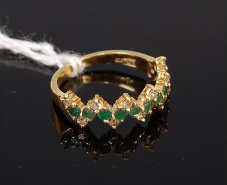 A modern 18ct gold emerald and diamond set half hoop ring, total emerald weight 0.3ct, total diamond weight 0.15ct, 2.8g, siz