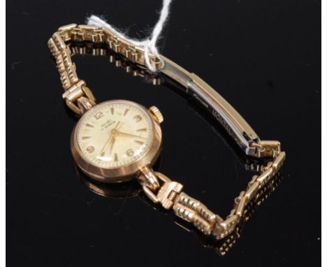 A Baume ladies 9ct gold cased wristwatch, having signed champagne dial, quarter Arabic numerals, and manual wind jewelled mov