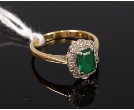 An 18ct gold and platinum emerald ring, the baguette cut four claw set emerald weighing approx 0.8ct, 3.5g, size N