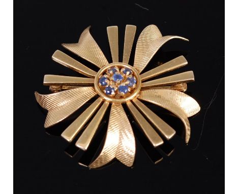 A modern engine turned 14ct gold and sapphire set flowerhead brooch, 6.4g, dia. 3.5cm