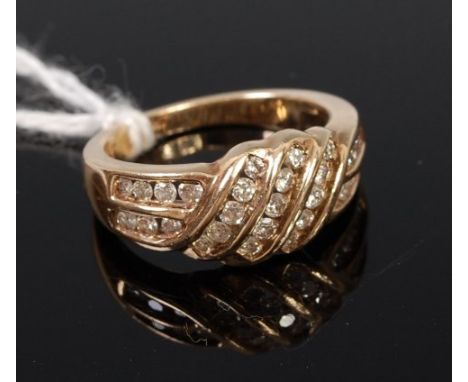 A modern 9ct gold multi-diamond set dress ring, the centre set with three rows of five small graduated brilliants, 5.3g, size