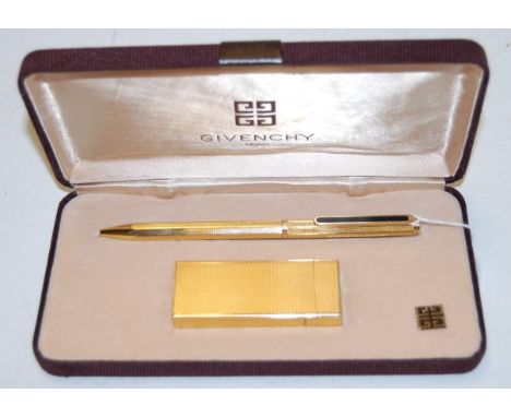 A modern Givenchy textured gilt pocket cigarette lighter together with a matching ballpoint pen in fitted case