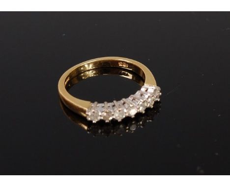 A modern 18ct gold diamond ring arranged as 7 claw set brilliants in a line setting, total diamond weight 0.33ct, 3.4g, size 