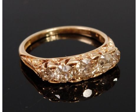 An 18ct gold and diamond five stone ring, the graduated old brilliants in a chased setting, total diamond weight estimated at