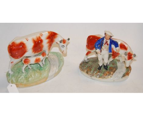 A Victorian Staffordshire figure of a cow and calf, in standing pose, having copper-sponge decoration and on naturalistic bas