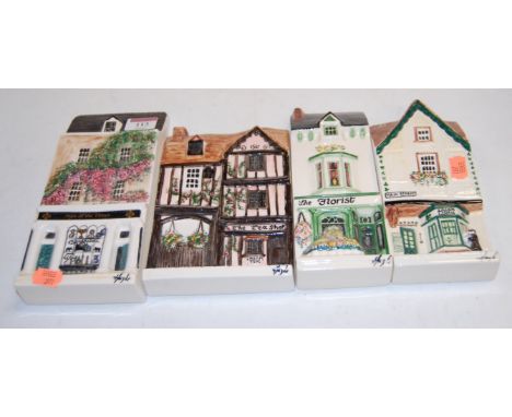 Four Hazel ceramic wall plaques, each depicting a shop, to include; Sign o' the Times pawnbroker, Teashop, Florist, and Irish