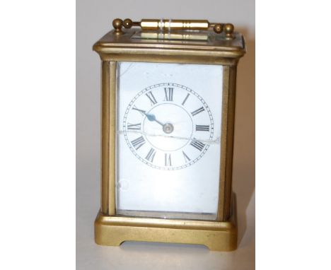 An early 20th century lacquered brass cased carriage clock, having enamelled dial with Roman numerals, visible platform lever