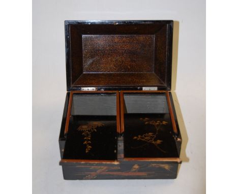 A Japanese Meiji period black lacquered tea caddy of sarcophagus form having raised gilt decoration, and twin compartment int