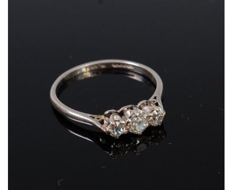 A platinum and diamond three stone ring, the claw set old cut diamonds in a line setting, the largest weighing approx 0.18ct,