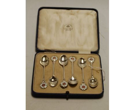 A cased set of six Mappin & Webb silver coffee spoons, with Yorkshire Rose enamel set terminals, Birmingham 1931