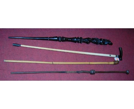 A late Victorian walking stick having bone shaft with silver collar and ebony handle, together with one other carved ebony tr